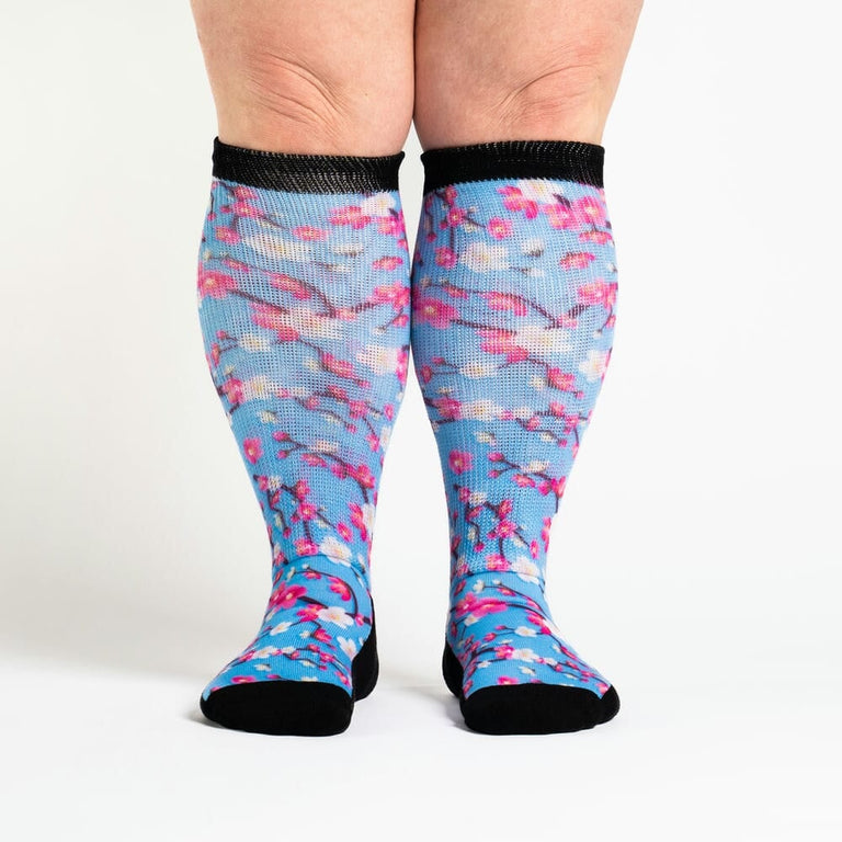 A person wearing cherry blossom socks